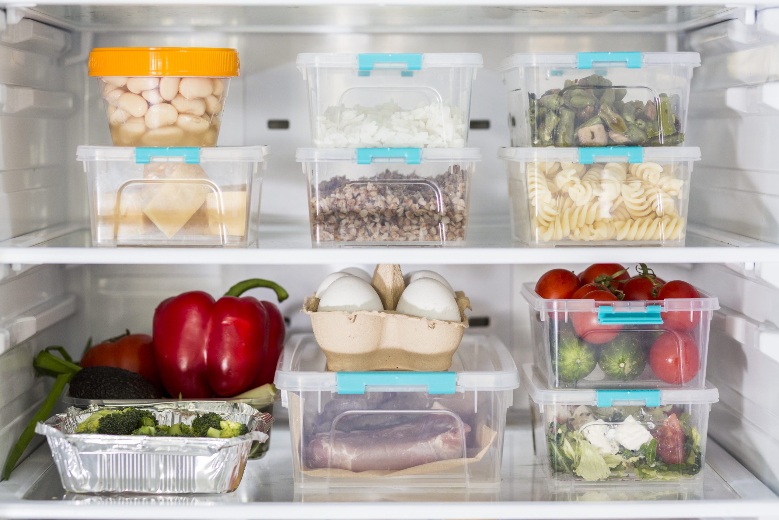 open-fridge-with-plastic-food-containers-vegetables